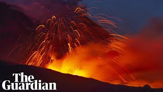 Mount Etna lights Sicilys night sky with red hot lava [upl. by Orihakat]